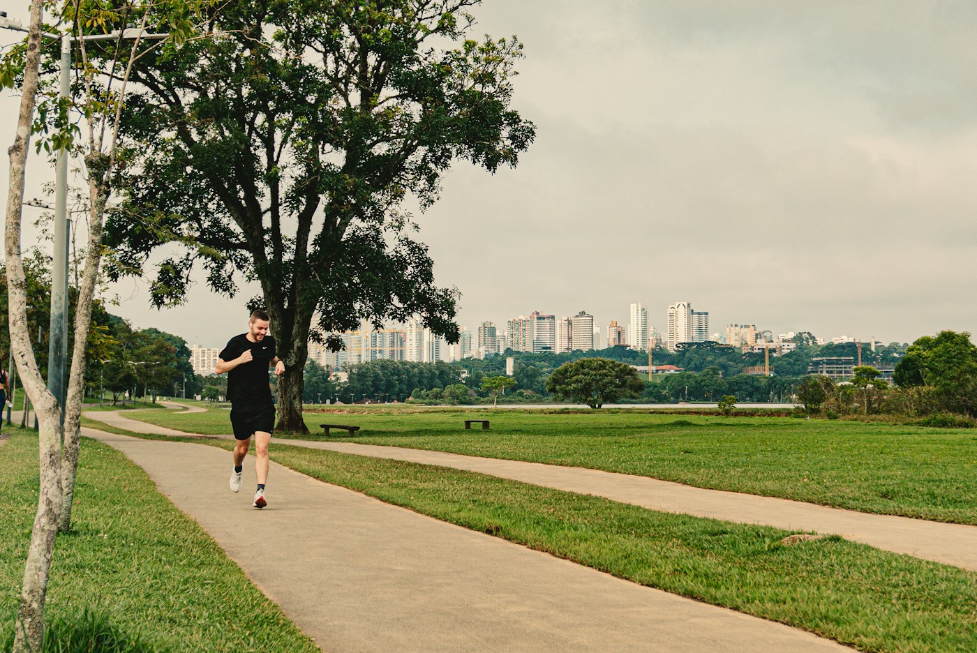 A man running along a sunlit path